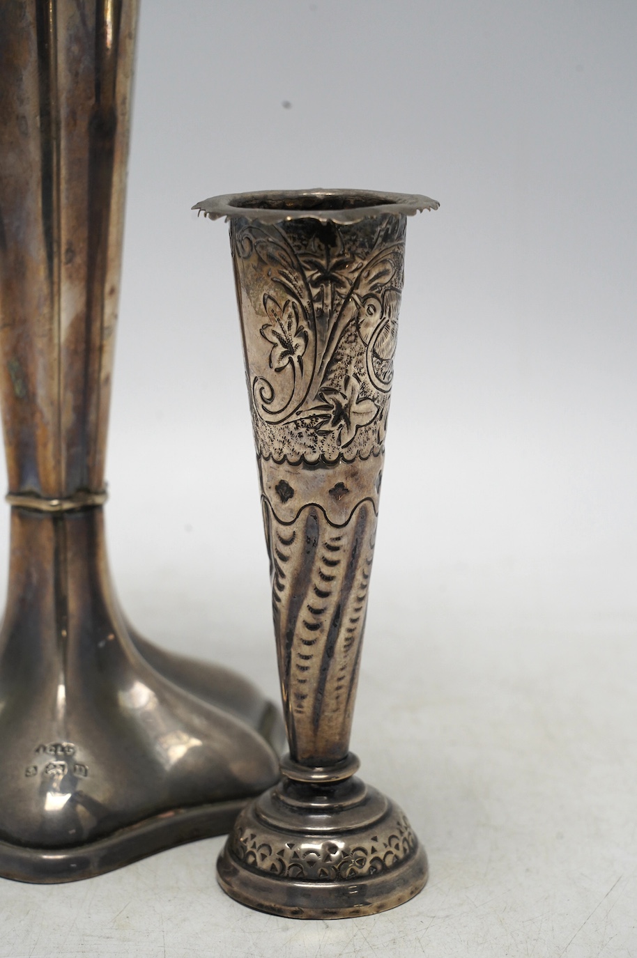 A George V pierced silver trumpet vase, Joseph Gloster Ltd, Birmingham, 1912, height 26.4cm, weighted, together with a smaller silver mounted posy vase. Condition - fair